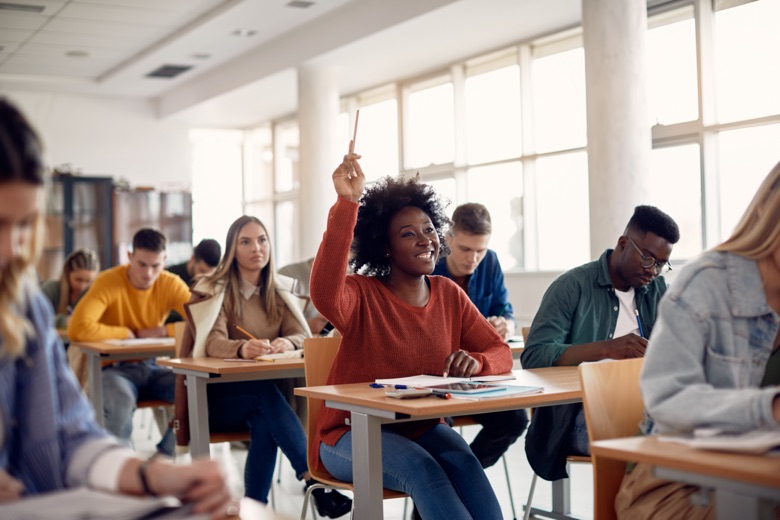 Happy,African,American,Student,Raising,Her,Hand,To,Ask,A